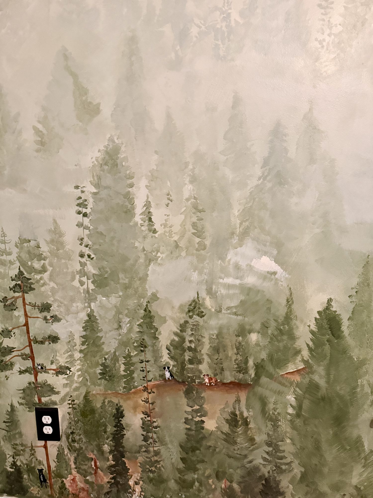Detail of a misty forest mural with tiny figures on a path between the pines