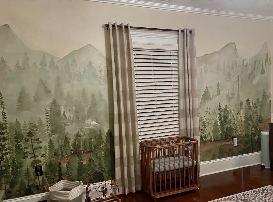 Misty pine forest nursery mural in China Grove, NC, with seven family pets hidden among the trees and a crib against the painted wall